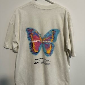 Above Millions Tee